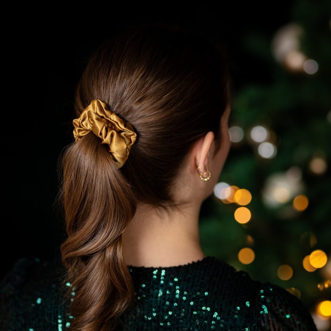 Brown hair styled with an extra glossy antique gold wide silk scrunchie 3.5 cm voluminous hair tie from behind