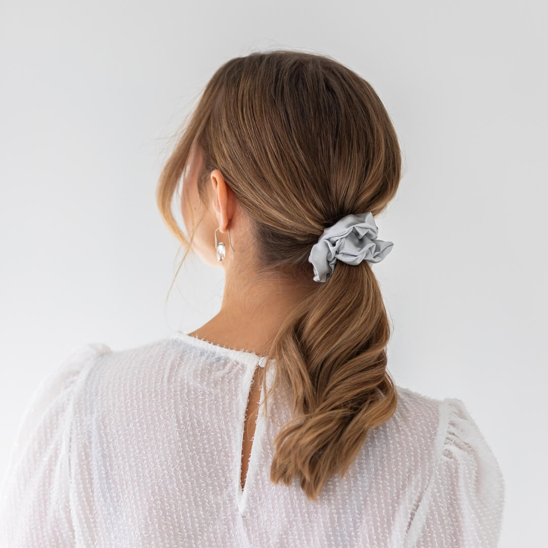 Brown hair styled with an extra glossy silver wide silk scrunchie 3.5 cm voluminous hair tie from behind