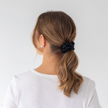 Brown hair styled with an extra glossy black wide silk scrunchie 3.5 cm voluminous hair tie from behind