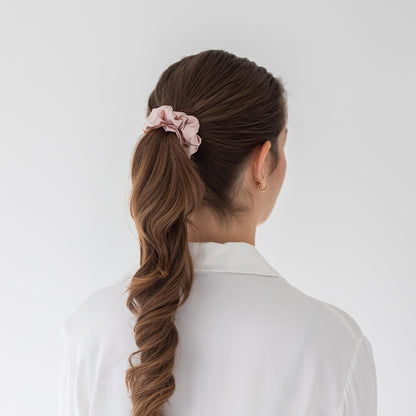 Brown hair styled with an extra glossy pink wide silk scrunchie 3.5 cm voluminous hair tie from behind