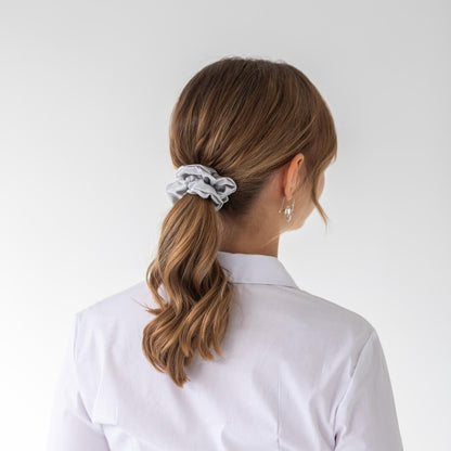 Brown hair styled with a silver wide silk scrunchie 3.5 cm voluminous hair tie from behind