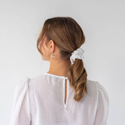 Brown hair styled with an ivory wide silk scrunchie 3.5 cm voluminous hair tie from behind