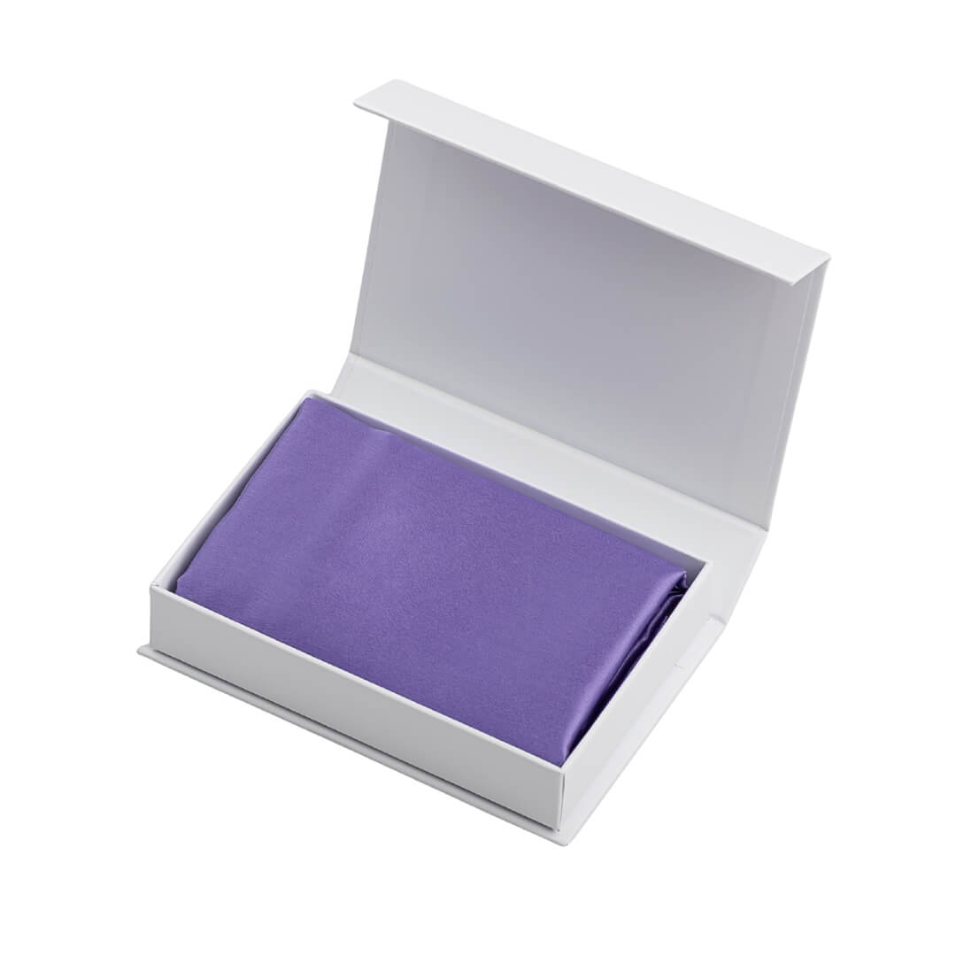 Lilac silk pillowcase in an open white gift box with silver branding