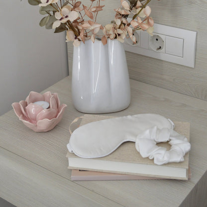Ivory silk hair scrunchie and silk sleep mask in a bedroom interior